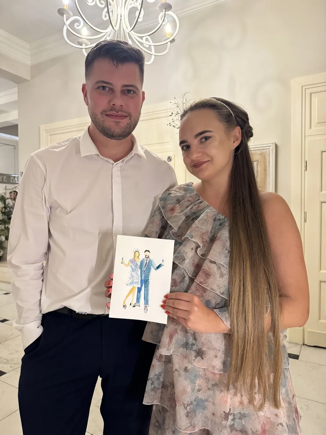Para gości pozuje z akwarelową ilustracją na weselu w Złotopolskiej Dolinie